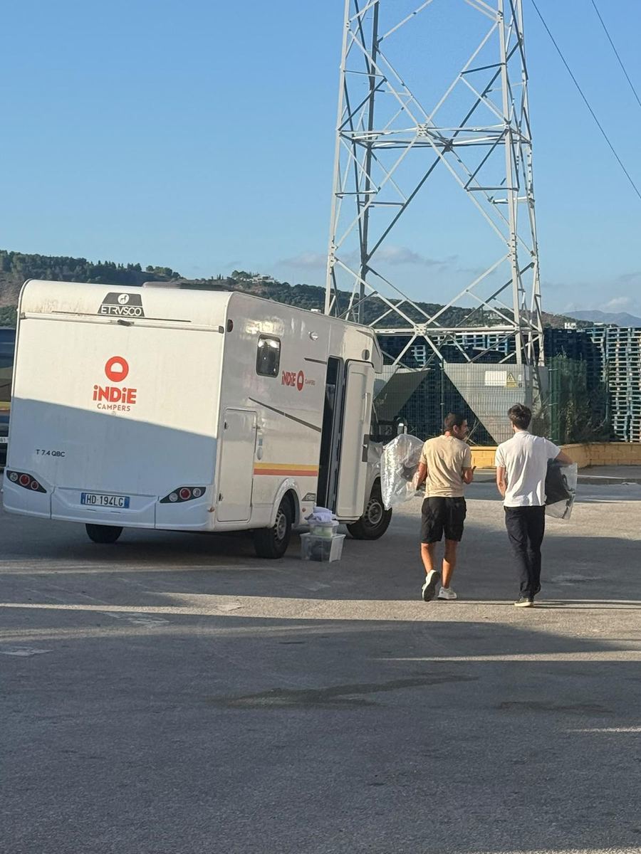 CostaSol team carrying baby equipment to a rental campervan